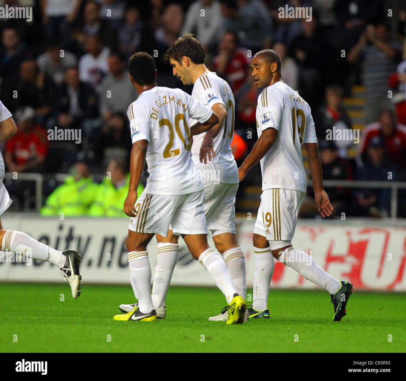 Liberty Stadium, Swansea, UK. 28th Aug 2012.   Pictured: Danny Graham of Swansea (C) with team mates Jonathan de Guzman (L) and Luke Moore (R) after his opening goal. Capital One Cup game, Swansea City FC v Barnsley at the Liberty Stadium, south Wales, UK. Credit:  D Legakis / Alamy Live News Stock Photo