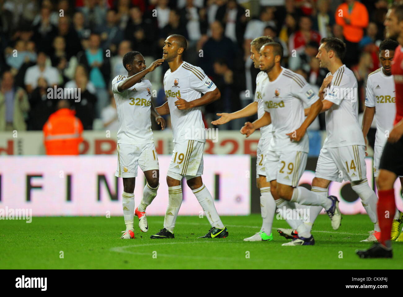 Liberty Stadium, Swansea, UK. 28th Aug 2012.   Pictured: Luke Moore of Swansea (C) celebrating his second goal with team mates Nathan Dyer (L) and Mark Gower (3rd L). Capital One Cup game, Swansea City FC v Barnsley at the Liberty Stadium, south Wales, UK. Credit:  D Legakis / Alamy Live News Stock Photo