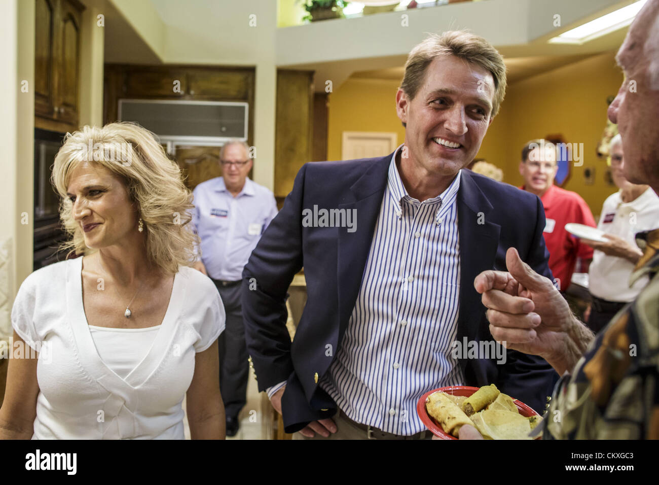 Mesa, Arizona, U.S. Aug. 28, 2012. Congressman JEFF FLAKE and his wife, CHERYL FLAKE, talk to supporters in their Mesa, AZ, home on election night. Flake is the incumbent Congressman from Arizona's 6th Congressional District. He won the Republican primary for the US Senate seat being vacated by retiring Senator Jon Kyl. Flake faced Arizona businessman and political newcomers Wil Cardon in the primary and won handily. (Credit Image: © Jack Kurtz/ZUMAPRESS.com) Stock Photo