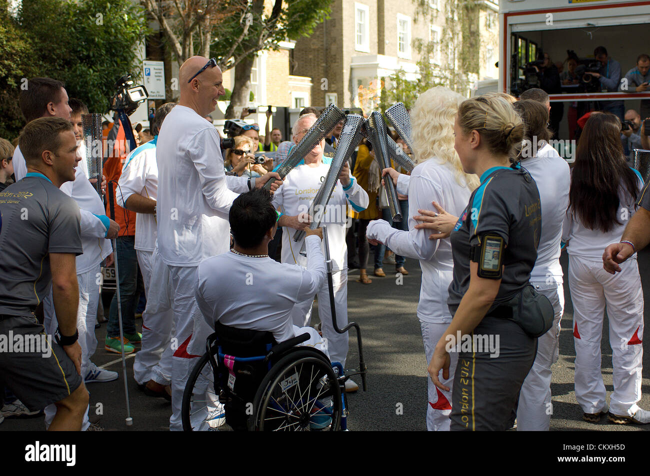 London UK. 29th Aug 2012. The Paralympic flame is passed between torchbearers in Carlton Hill, St. John's Wood on the last day of its journey to the Olympic Stadium, Wednesday 29 August 2012. Credit:  Richard Slater / Alamy Live News Stock Photo