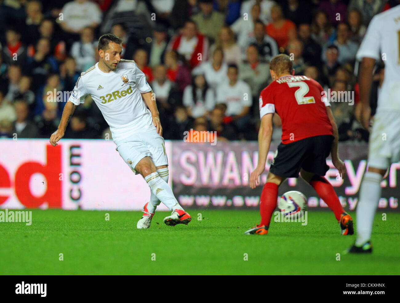 Pictured L-R: Stephen Dobbie of Swansea against Bobby Hassell of Barnsley. Tuesday 28 August 2012  Re: Capital One Cup game, Swansea City FC v Barnsley at the Liberty Stadium, south Wales. Stock Photo