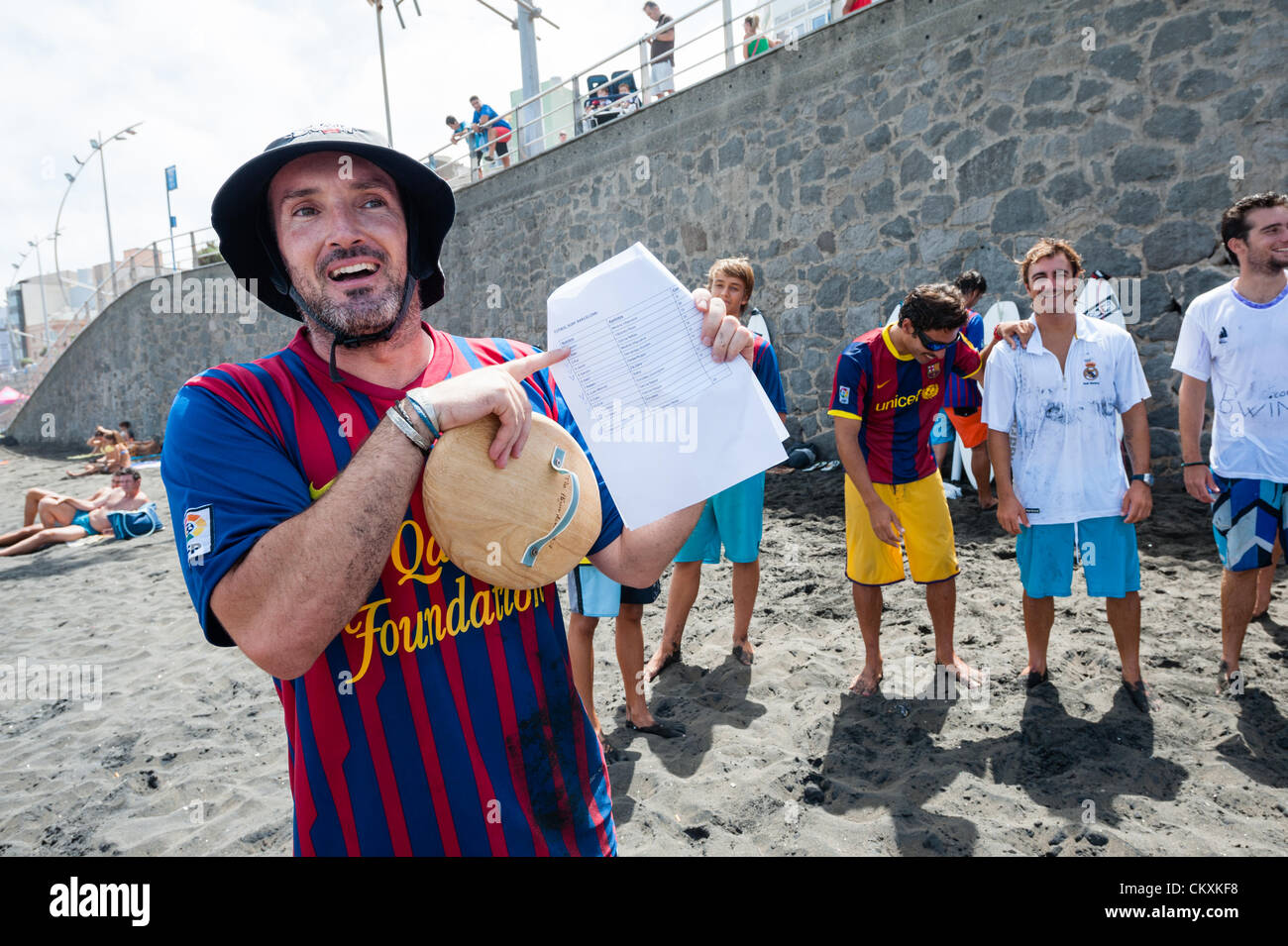 LAS PALMAS, CANARIAS ISLANDS, SPAIN–AUGUST 29, 2012: Unidentified young surfers from University Surf School and Surf Camp Las Palmas during an informal competition, formed as an football match with 11 surfers in each team, one team is wearing T-shirts from football club F.C. Barcelona, the other one from Real Madrid. Stock Photo