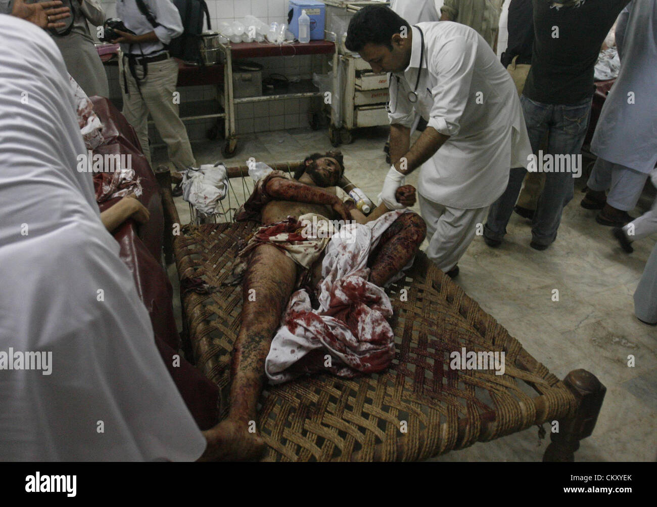 Paramedics busy in treatment of a bomb blast injures in Lady Reading hospital. A blast occurred in Matni Market located in Peshawar, killing at least six people and injuring thirteen others on Friday, August 31, 2012 Stock Photo