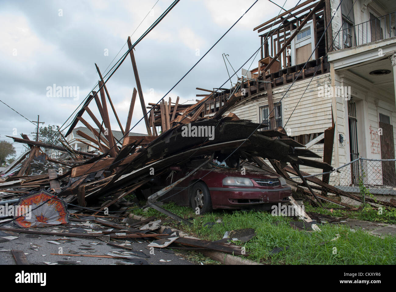 Isaac's winds topple house on top of four parked cars on N. Miro and N. Columbus streets in New Orleans on early Wednesday morning, August 29 2012. Stock Photo