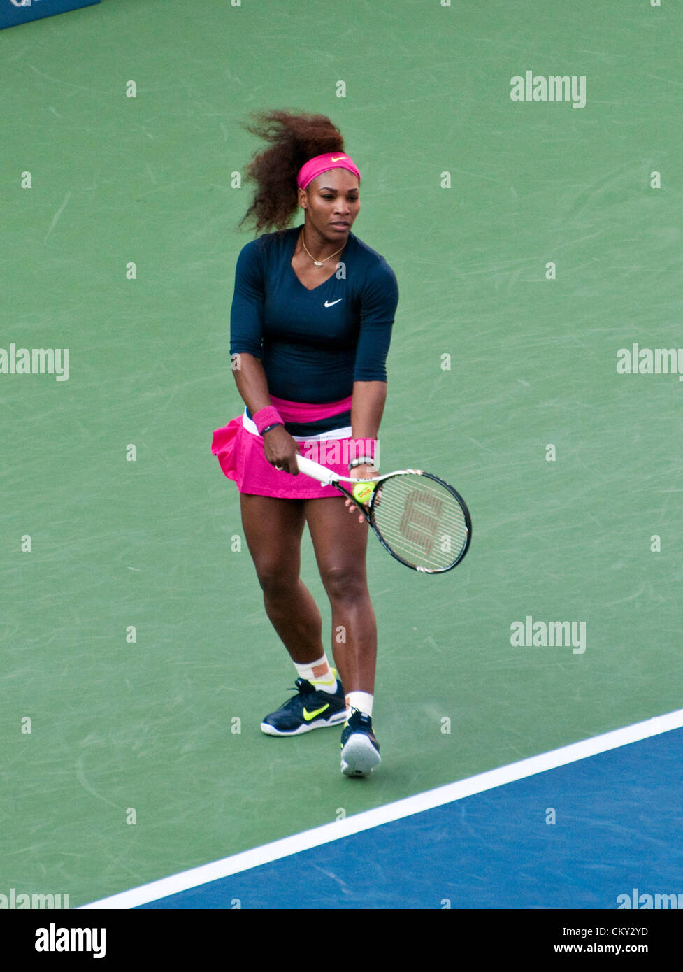 Serena Williams of the USA serving during the women's doubles second round match on Day Five of the 2012 US Open on August 31, 2012. She and her sister, Venus WIlliams, are playing against Kristina Mladenovic of France, and Klaudia Jans-Ignacik of Poland at the Billie Jean King National Tennis Center in Flushing, New York. Stock Photo
