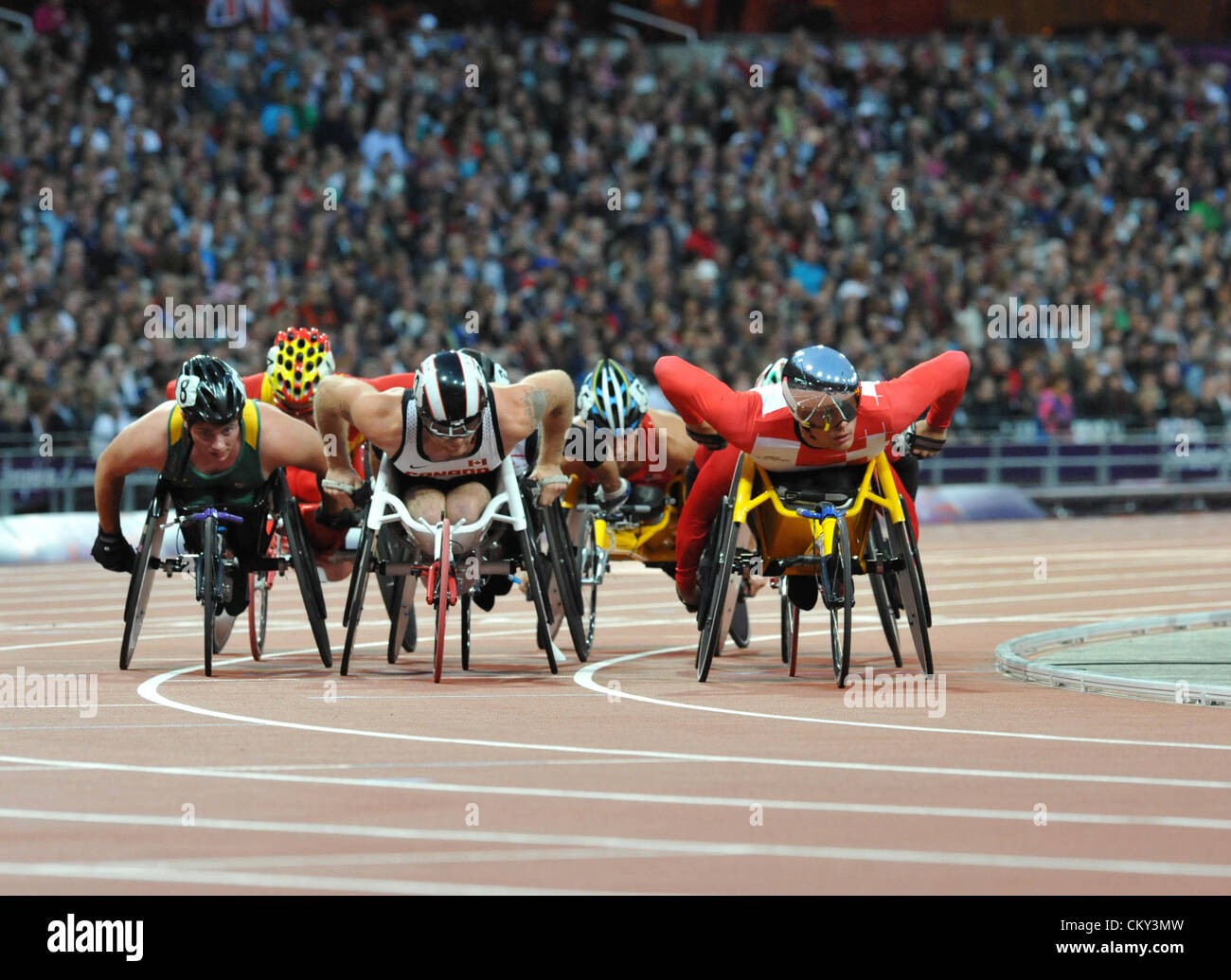 London, UK. 31st Aug 2012 - Marcell Hug (in reflective helmet and googles) leading the pack during a heat for the 5000m T54 race in the Olympic stadium at the 2012 London Summer Paralympics. Front row, right to left is: Natheniel Arkley (AUS), Josh Cassidy (CAN), Marcell Hug (SUI). (C) Michael Preston / Alamy Live News. Stock Photo