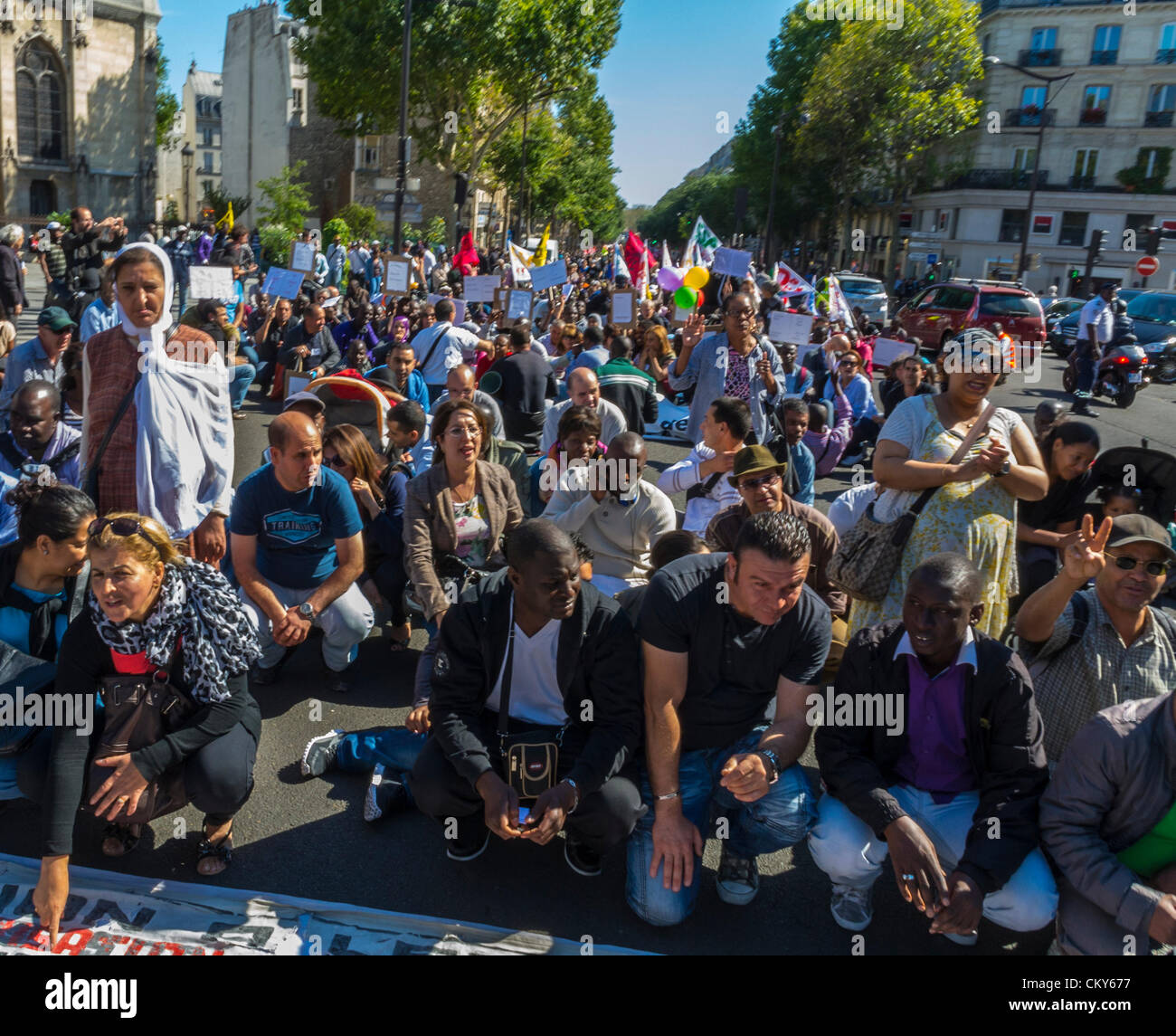 Paris, France, African Immigrants Without Documents , 'Sans Papiers', Demonstration, Sitting on Street, réfugiés Blocking Traffic, against immigration law protest, europe migrants, large multicultural crowd, integrated, protesters multiracial human rights, sit in, illegal migrants, crowd of people from front Stock Photo