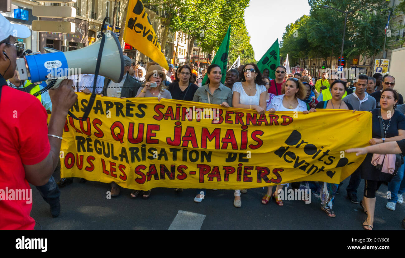 Paris, France, Collective Immigrants Without Documents , Women Holding Banners, Sans Papiers, Demonstration, anti immigration law protest, angry crowd, immigration rally, peaceful protest sign, illegal migrants, demo megaphone Stock Photo