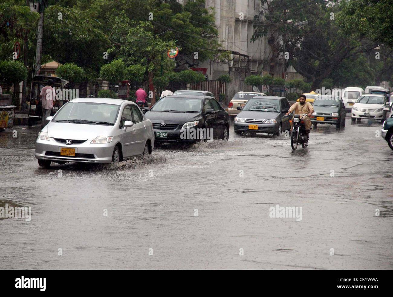 Saheed Road Commuters pass through rain water that was stand at Sarwar Shaheed road ...