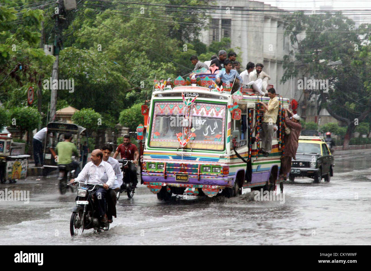 Saheed Road Commuters pass through rain water that was stand at Sarwar Shaheed road ...