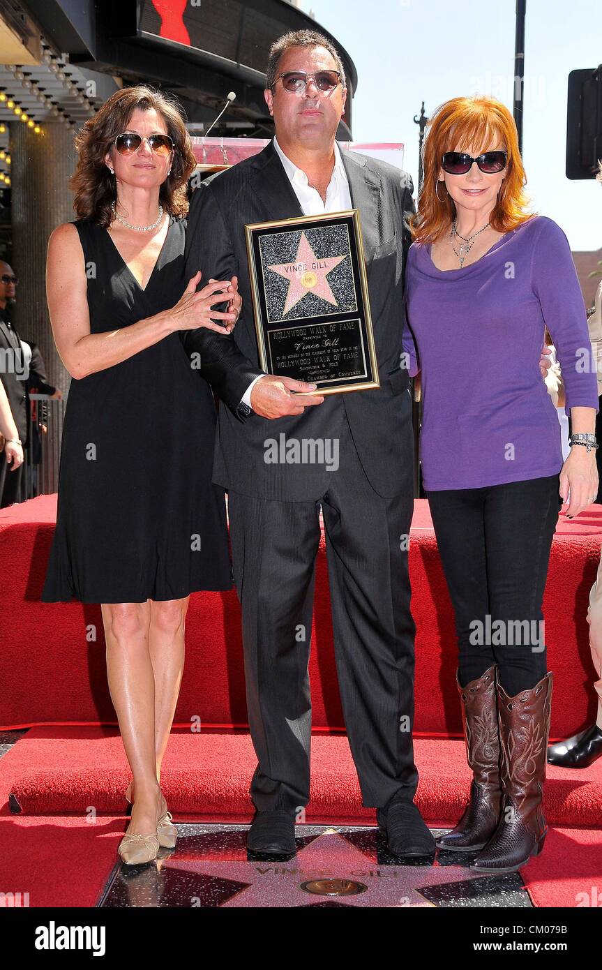 Amy Grant, Vince Gill, Reba McEntire at the induction ceremony for Star on the Hollywood Walk of Fame for Vince Gill, Hollywood Boulevard, Los Angeles, CA September 6, 2012. Photo By: Michael Germana/Everett Collection Stock Photo