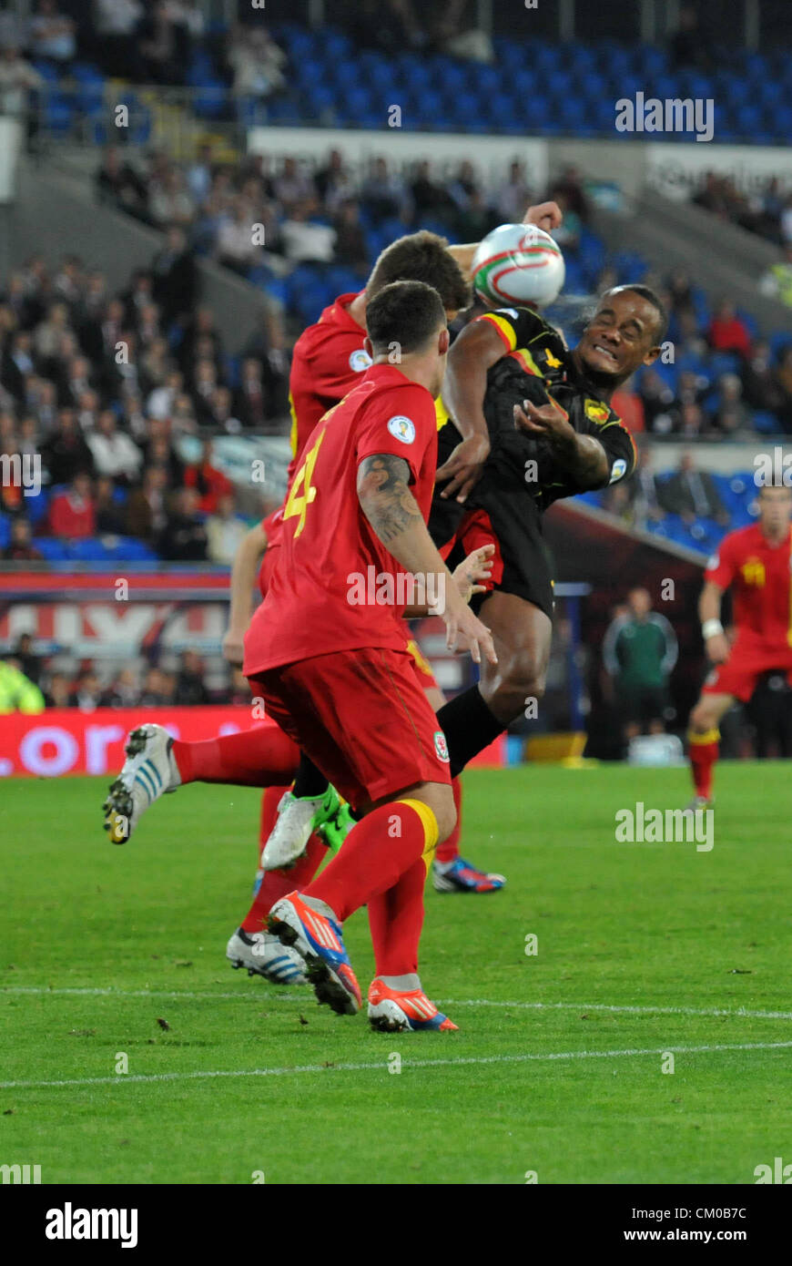 FIFA 2014 World Cup Qualifying Match - Wales v Belgium at the Cardiff City Stadium : Vincent Kompany of Belgium is beaten to the high ball by Sam Vokes of Wales. Stock Photo