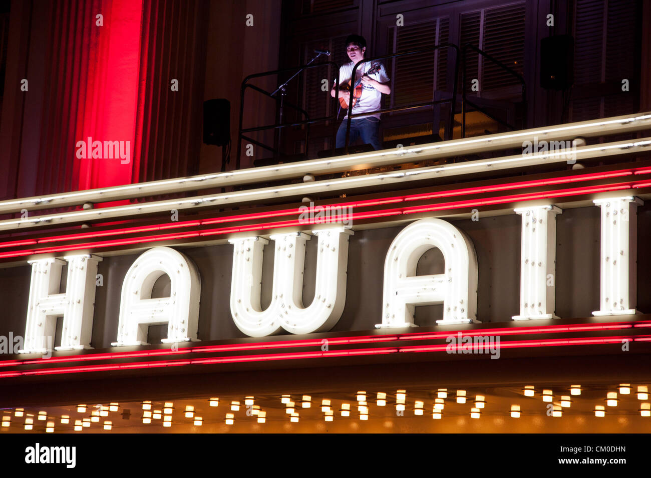 Honolulu, Hawaii. 7th September 2012. Jake Shimabukuro, master of the ukulele plays atop The Hawaii Theater marquee on September 7, 2012 in Honolulu, Hawaii. Jake Shimabukuro is the first person ever to perform on the marquee and is performing in advance of his upcoming release, “Grand Ukulele” produced by Alan Parsons who produced The Beatles “Abby Road” and Pink Floyd’s Dark Side of the Moon”. “Grand Ukulele” also features covers of Adele’s “Rolling In the Deep,” Sting’s “Fields of Gold” and the Judy Garland classic “Over the Rainbow.” Stock Photo