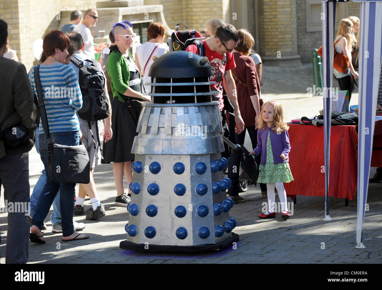 Brighton UK 8th September 2012 - A young spectator is transfixed as a dalek mingles with the crowds at the Brighton Mini Maker Faire at The Corn Exchange and The Dome today . The fair has a mixture of gadgets and technology on display. Credit:  Simon Dack / Alamy Live News Stock Photo