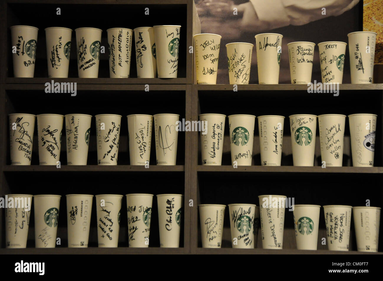 London, UK, Wednesday 5th September 2012. Starbucks coffee cups, signed by Olympic and Paralympic competitors, lined up on a she Stock Photo