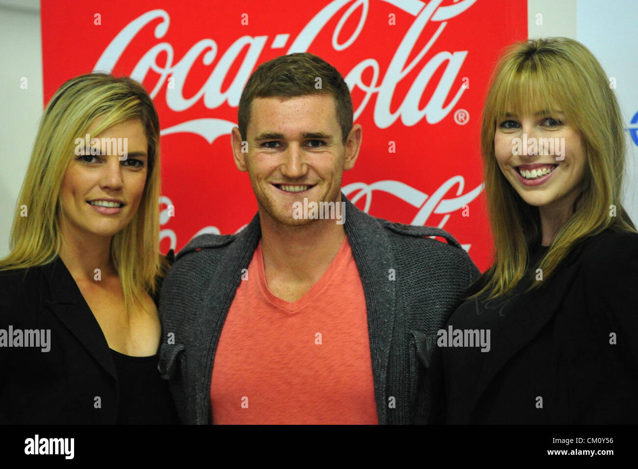 PORT ELIZABETH, SOUTH AFRICA: Olympic gold medalist Cameron van der Burgh with Tanya Hyman (L) and Jolene van Ree (R) on September 10, 2012 in Port Elizabeth, South Africa. (Photo by Gallo Images / Foto24 / Deon Ferreira) Stock Photo