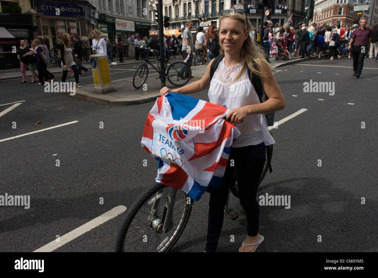 London, 10th September 2012. Olympic fan leaves the athletes' parade in the City of London. The day after the end of the London 2012 Paralympics, thousands of spectators lined the capital's streets to honour 800 of TeamGB's athletes and Paralympians. Britain's golden generation of athletes in turn said thank you to its Olympic followers, paying tribute to London and a wider Britain as up to a million people lined the streets to celebrate the “greatest ever” sporting summer and billed to be the biggest sporting celebration ever seen in the UK. Stock Photo