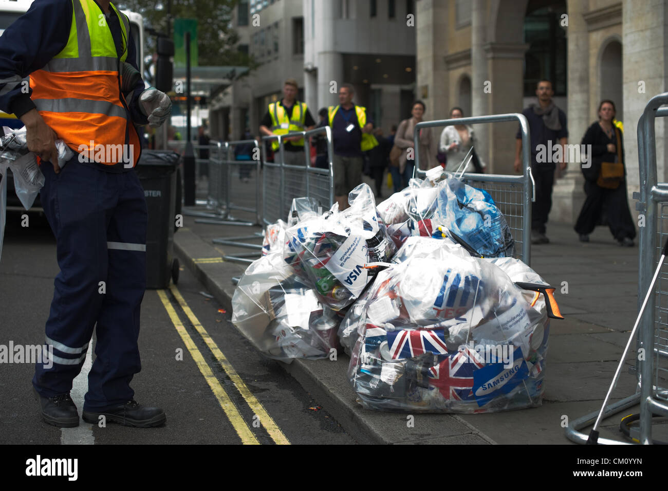 The Strand, London, UK. September 10, 2012 A Westminster Council worker clears up debris after the Olympic and Paralympic Victory Parade has passed through. Stock Photo