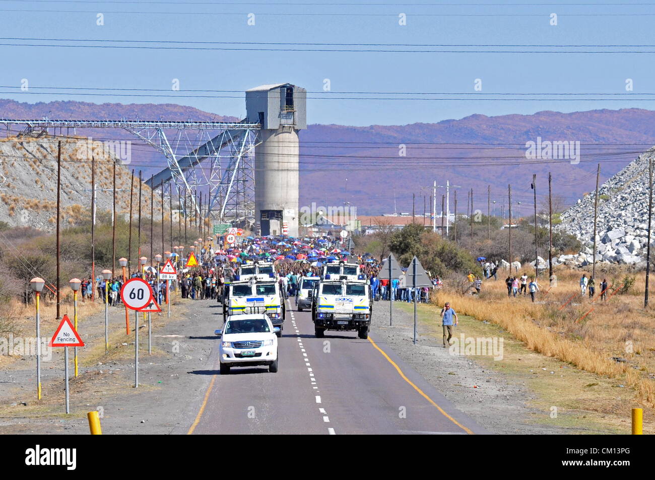 RUSTENBURG, SOUTH AFRICA: Lonmin mine workers march to three different mines demanding that shafts be closed down and workers join them in their wage strike on September 10, 2012 in Rustenburg, South Africa. The workers have been protesting for over three weeks. (Photo by Gallo Images / Dino Lloyd) Stock Photo