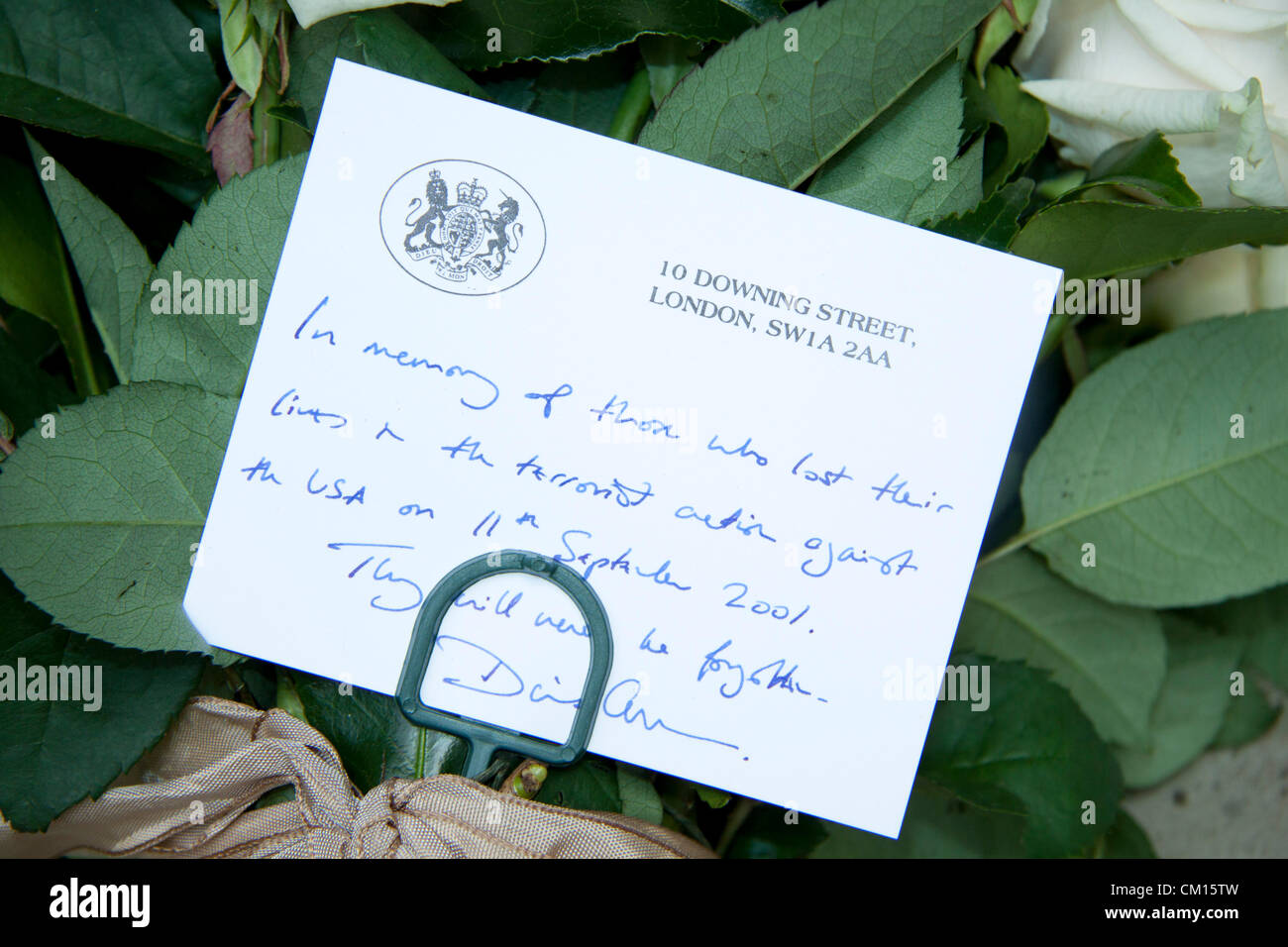London, UK. 11th September 2012. A condolence card signed by the British  Prime Minister David Cameron to the victims of the 11 September  2001 terrorist attacks at a remembrance ceremony outside the US embassy in London. Stock Photo