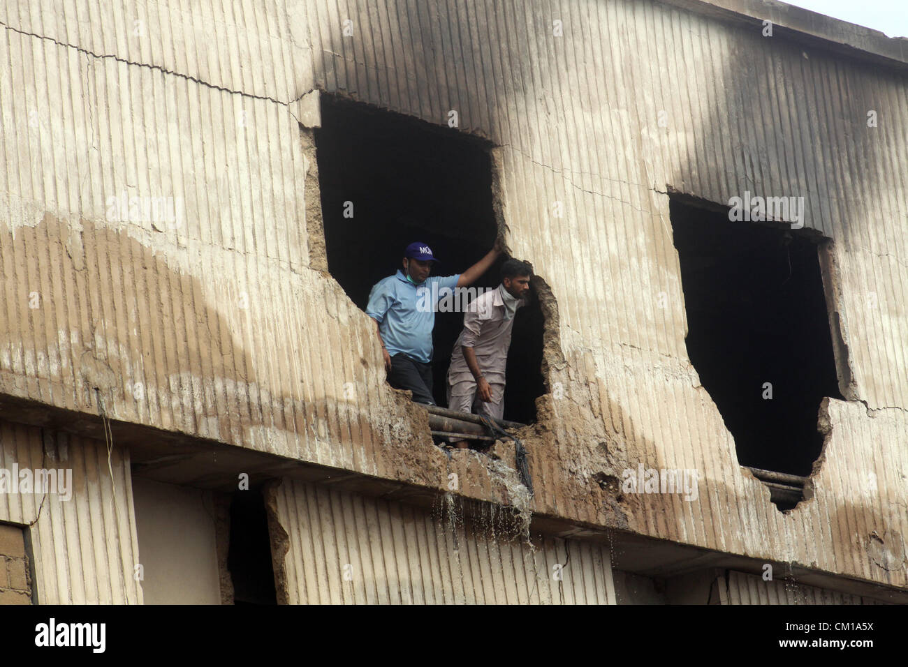 Rescue workers busy to complete rescue work at the site of burnt garment factory in Karachi September 12, 2012. Atleast 289 workers were burnt when fire engulfed a garment factory in Karachi. Stock Photo