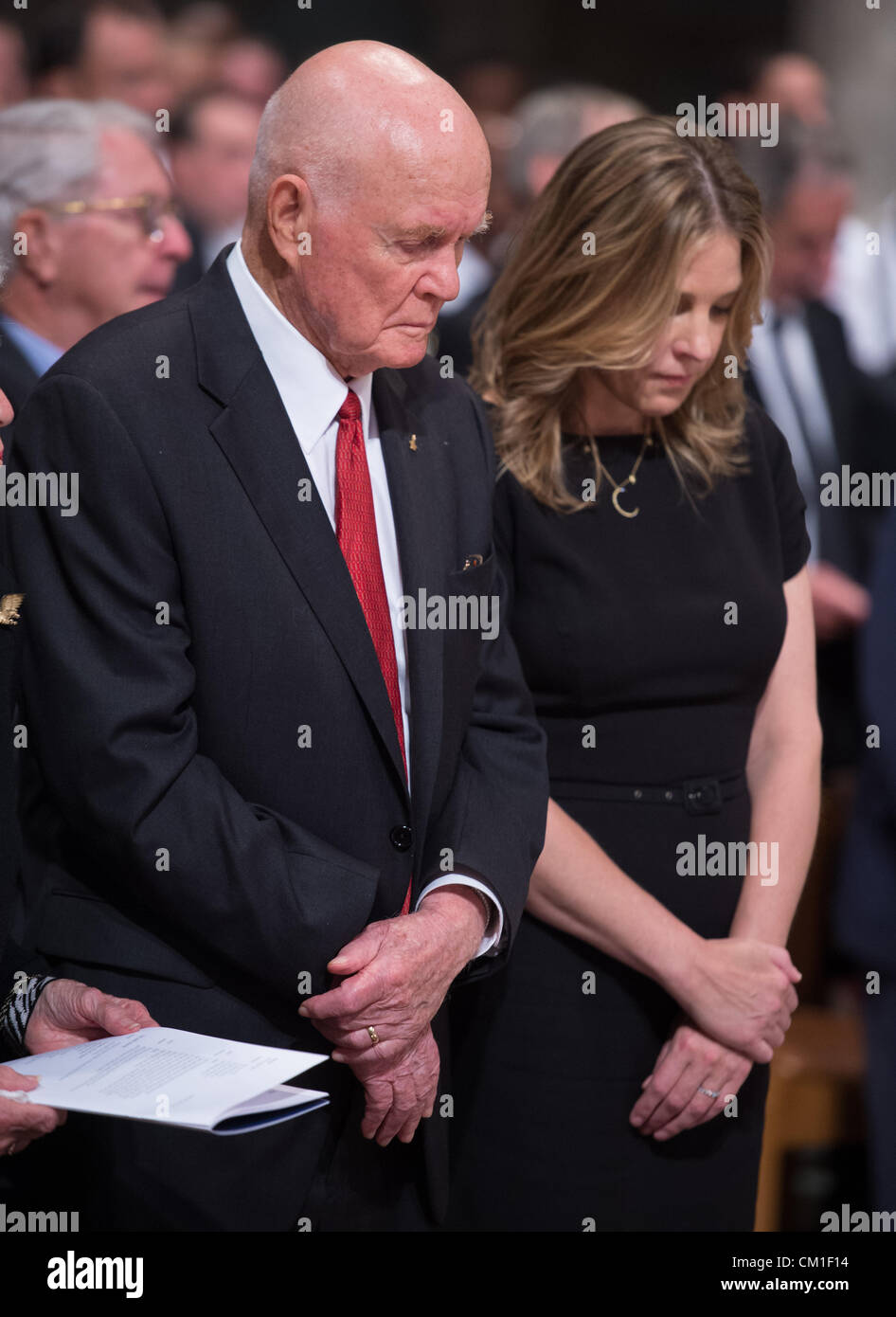 Former astronaut and US Senator John Glenn, left, and musician Diana Krall bow there heads in prayer during a memorial service celebrating the life of Neil Armstrong September 13, 2012 at the National Cathedral in Washington, DC. Armstrong, the first man to walk on the moon during the 1969 Apollo 11 mission, died August 25. He was 82. Stock Photo