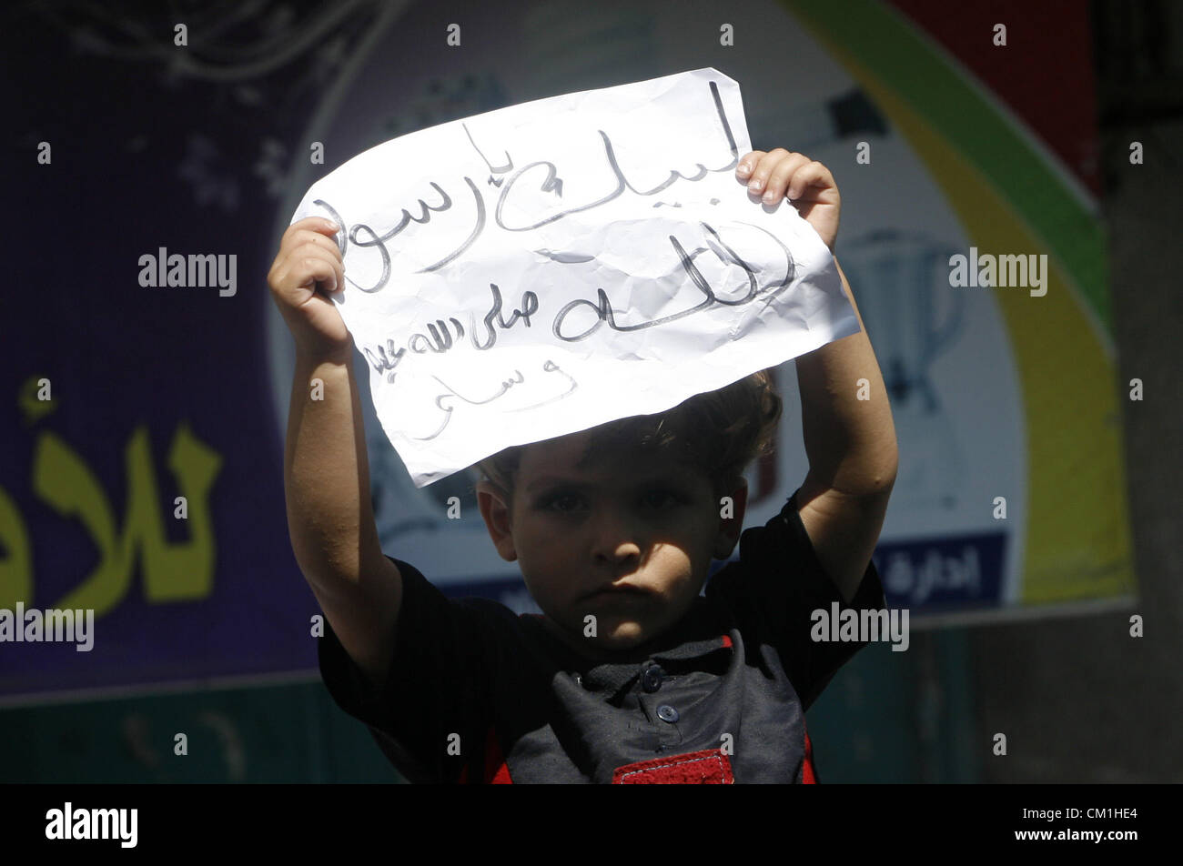 Sept. 14, 2012 - Rafah, Gaza Strip, Palestinian Territory - A Palestinian child holds a placard during a demonstration against the controversial film 'Innocence of Muslims' in Rafah southern Gaza strip, on September 14, 2012. The controversial low budget film reportedly made by an Israeli-American which portrays Muslims as immoral and gratuitous, sparked fury in Libya, where four Americans including the ambassador were killed on Tuesday when a mob attacked the US consulate in Benghazi, and has led to protests outside US missions in Morocco, Sudan, Egypt, Tunisia and Yemen  (Credit Image: © Eya Stock Photo