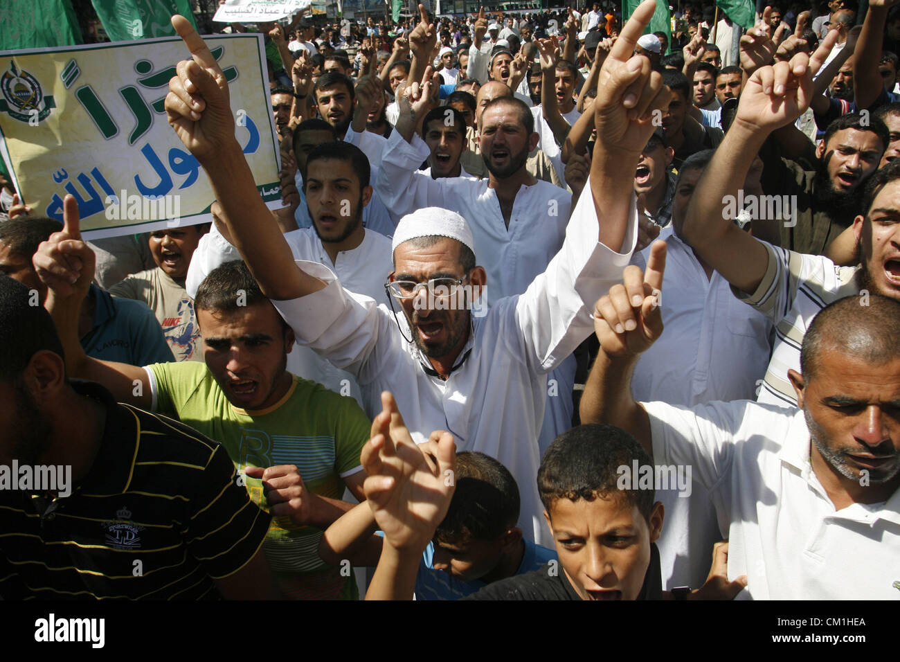 Sept. 14, 2012 - Rafah, Gaza Strip, Palestinian Territory - Palestinians hold placards as they shout anti-U.S. slogans during a demonstration against the controversial film 'Innocence of Muslims' in Rafah southern Gaza strip, on September 14, 2012. The controversial low budget film reportedly made by an Israeli-American which portrays Muslims as immoral and gratuitous, sparked fury in Libya, where four Americans including the ambassador were killed on Tuesday when a mob attacked the US consulate in Benghazi, and has led to protests outside US missions in Morocco, Sudan, Egypt, Tunisia and Yeme Stock Photo