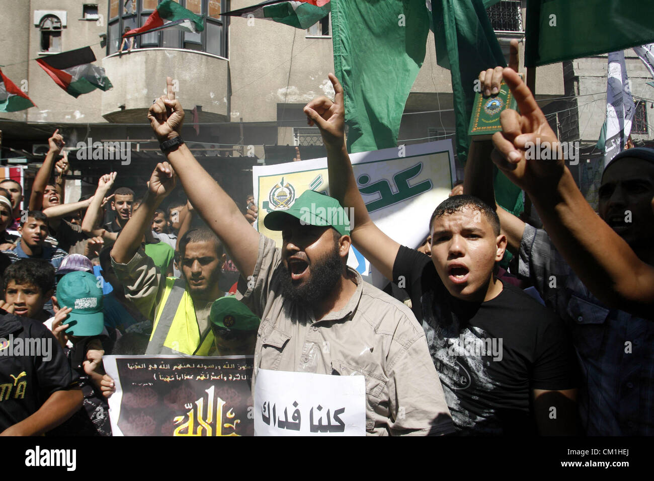 Sept. 14, 2012 - Rafah, Gaza Strip, Palestinian Territory - Palestinians hold placards as they shout anti-U.S. slogans during a demonstration against the controversial film 'Innocence of Muslims' in Rafah southern Gaza strip, on September 14, 2012. The controversial low budget film reportedly made by an Israeli-American which portrays Muslims as immoral and gratuitous, sparked fury in Libya, where four Americans including the ambassador were killed on Tuesday when a mob attacked the US consulate in Benghazi, and has led to protests outside US missions in Morocco, Sudan, Egypt, Tunisia and Yeme Stock Photo