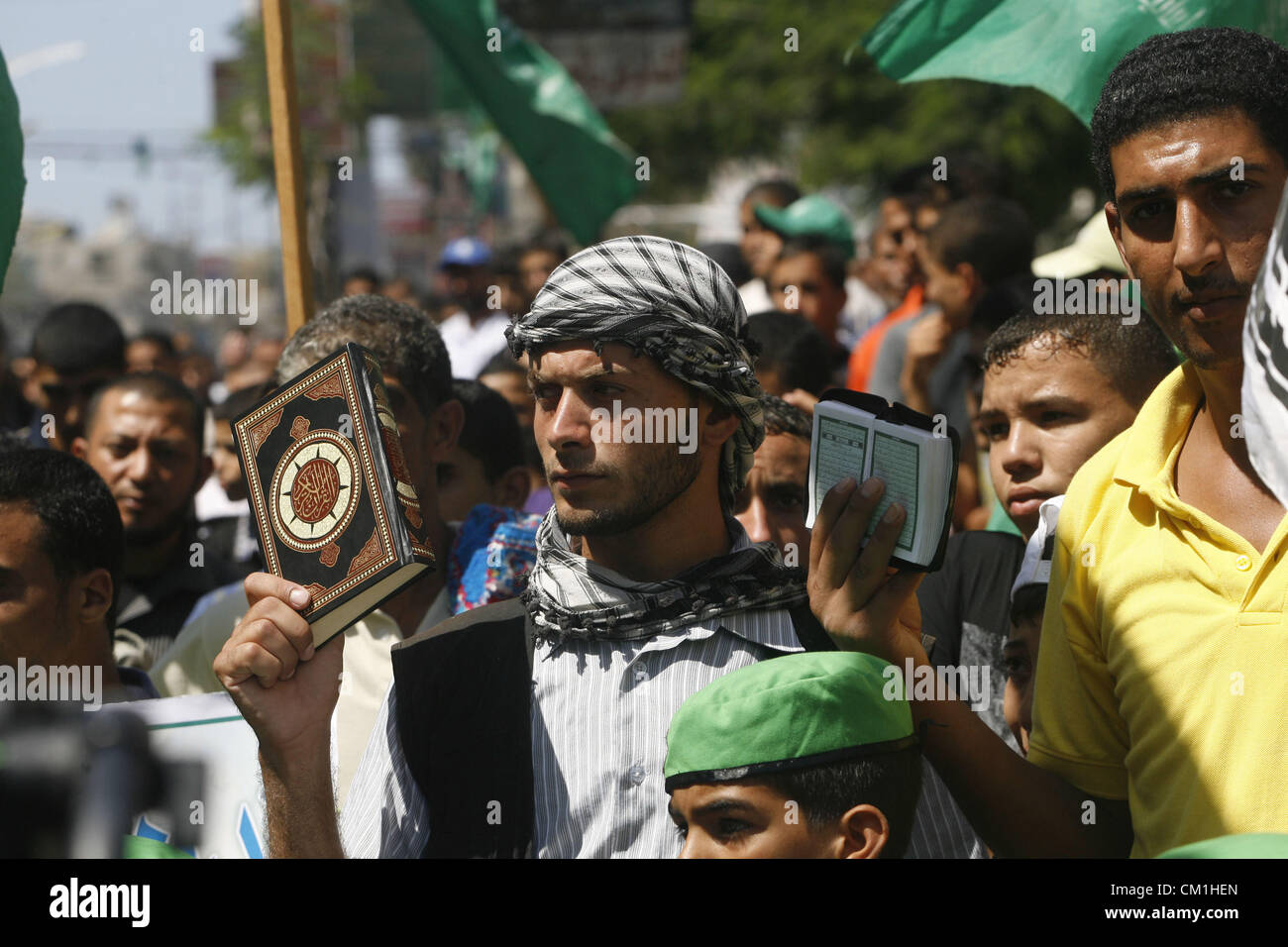 Sept. 14, 2012 - Rafah, Gaza Strip, Palestinian Territory - Palestinians hold placards as they shout anti-U.S. slogans during a demonstration against the controversial film 'Innocence of Muslims' in Rafah southern Gaza strip, on September 14, 2012. The controversial low budget film reportedly made by an Israeli-American which portrays Muslims as immoral and gratuitous, sparked fury in Libya, where four Americans including the ambassador were killed on Tuesday when a mob attacked the US consulate in Benghazi, and has led to protests outside US missions in Morocco, Sudan, Egypt, Tunisia and Yeme Stock Photo