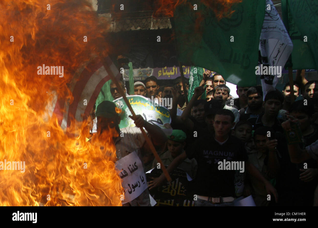 Sept. 14, 2012 - Rafah, Gaza Strip, Palestinian Territory - Palestinians burn the U.S. flag during a demonstration against the controversial film 'Innocence of Muslims' in Rafah southern Gaza strip, on September 14, 2012. The controversial low budget film reportedly made by an Israeli-American which portrays Muslims as immoral and gratuitous, sparked fury in Libya, where four Americans including the ambassador were killed on Tuesday when a mob attacked the US consulate in Benghazi, and has led to protests outside US missions in Morocco, Sudan, Egypt, Tunisia and Yemen  (Credit Image: © Eyad Al Stock Photo