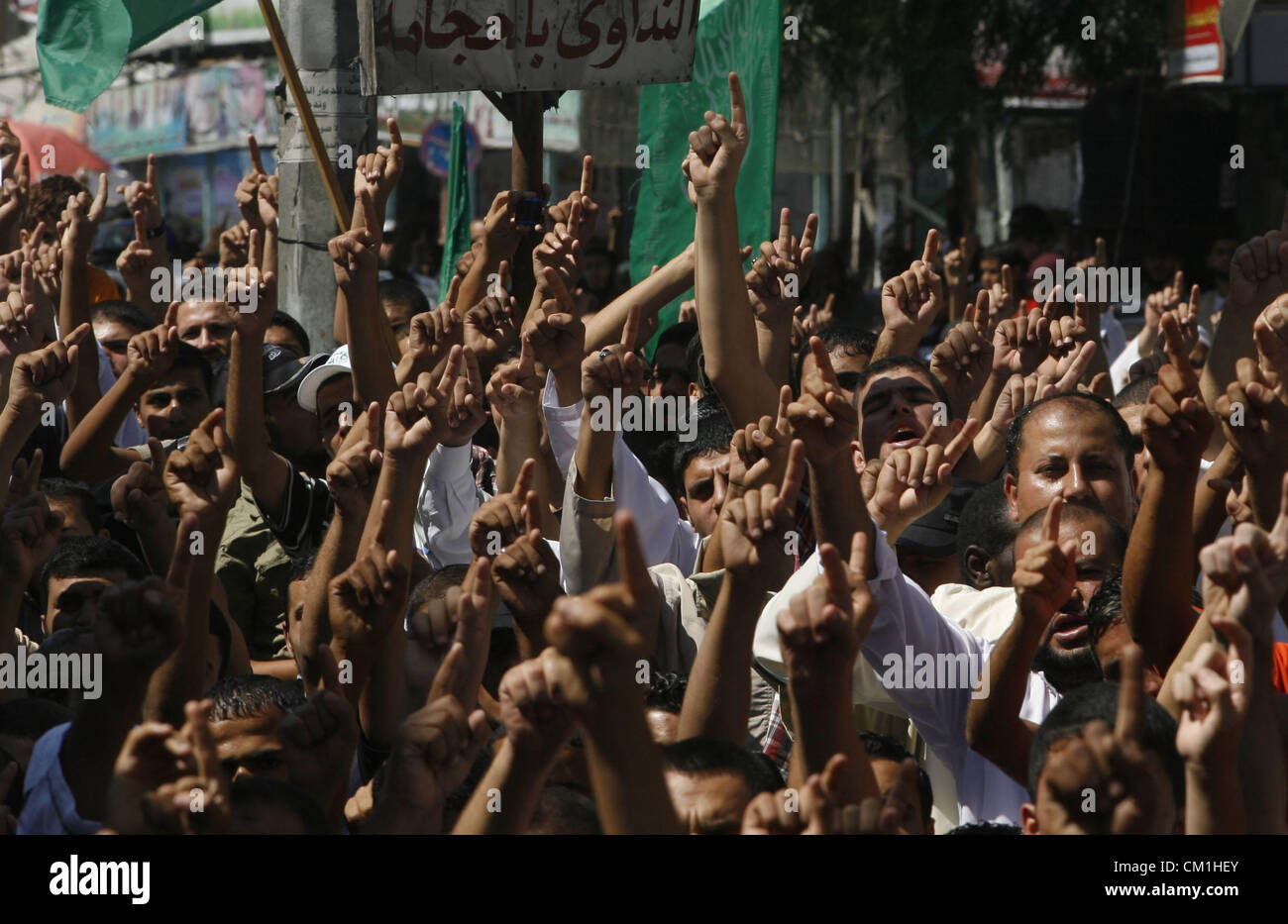 Sept. 14, 2012 - Rafah, Gaza Strip, Palestinian Territory - Palestinians hold placards as they shout anti-U.S. slogans during a demonstration against the controversial film 'Innocence of Muslims' in Rafah southern Gaza strip, on September 14, 2012. The controversial low budget film reportedly made by an Israeli-American which portrays Muslims as immoral and gratuitous, sparked fury in Libya, where four Americans including the ambassador were killed on Tuesday when a mob attacked the US consulate in Benghazi, and has led to protests outside US missions in Morocco, Sudan, Egypt, Tunisia and Yeme Stock Photo