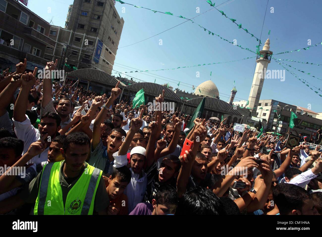 Sept. 14, 2012 - Gaza City, Gaza Strip, Palestinian Territory - Palestinians hold placards as they shout anti-U.S. slogans during a demonstration against the controversial film 'Innocence of Muslims' in Khan Younis southern Gaza strip, on September 14, 2012. The controversial low budget film reportedly made by an Israeli-American which portrays Muslims as immoral and gratuitous, sparked fury in Libya, where four Americans including the ambassador were killed on Tuesday when a mob attacked the US consulate in Benghazi, and has led to protests outside US missions in Morocco, Sudan, Egypt, Tunisi Stock Photo