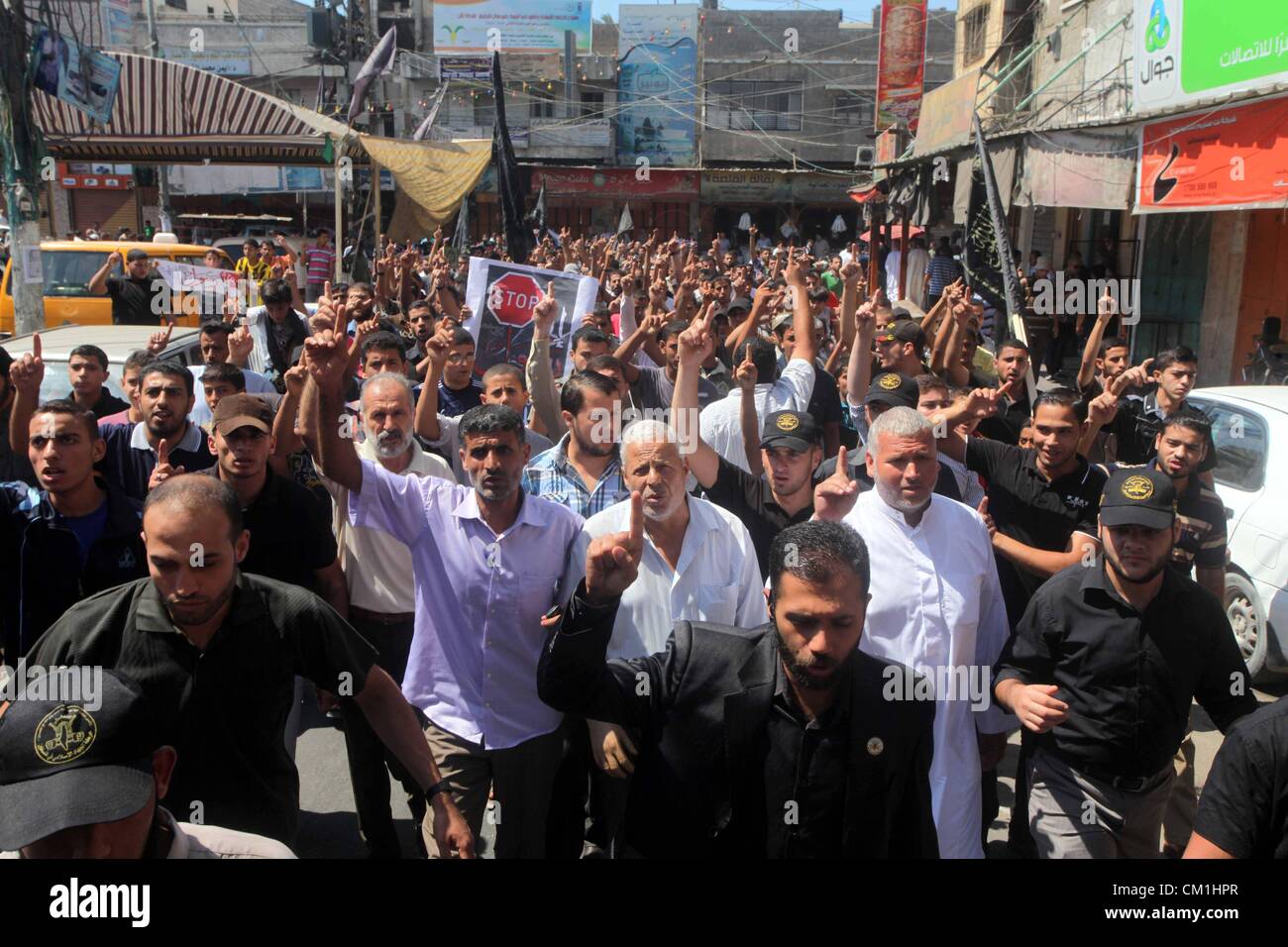 Sept. 14, 2012 - Gaza City, Gaza Strip, Palestinian Territory - Palestinians hold placards as they shout anti-U.S. slogans during a demonstration against the controversial film 'Innocence of Muslims' in Khan Younis southern Gaza strip, on September 14, 2012. The controversial low budget film reportedly made by an Israeli-American which portrays Muslims as immoral and gratuitous, sparked fury in Libya, where four Americans including the ambassador were killed on Tuesday when a mob attacked the US consulate in Benghazi, and has led to protests outside US missions in Morocco, Sudan, Egypt, Tunisi Stock Photo