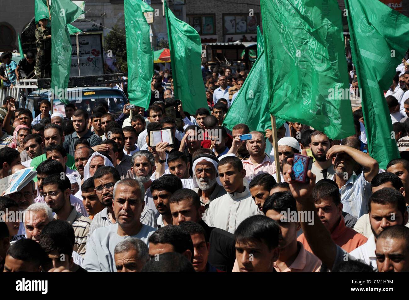 Sept. 14, 2012 - Gaza City, Gaza Strip, Palestinian Territory - Palestinians hold placards as they shout anti-U.S. slogans during a demonstration against the controversial film 'Innocence of Muslims' in Khan Younis southern Gaza strip, on September 14, 2012. The controversial low budget film reportedly made by an Israeli-American which portrays Muslims as immoral and gratuitous, sparked fury in Libya, where four Americans including the ambassador were killed on Tuesday when a mob attacked the US consulate in Benghazi, and has led to protests outside US missions in Morocco, Sudan, Egypt, Tunisi Stock Photo