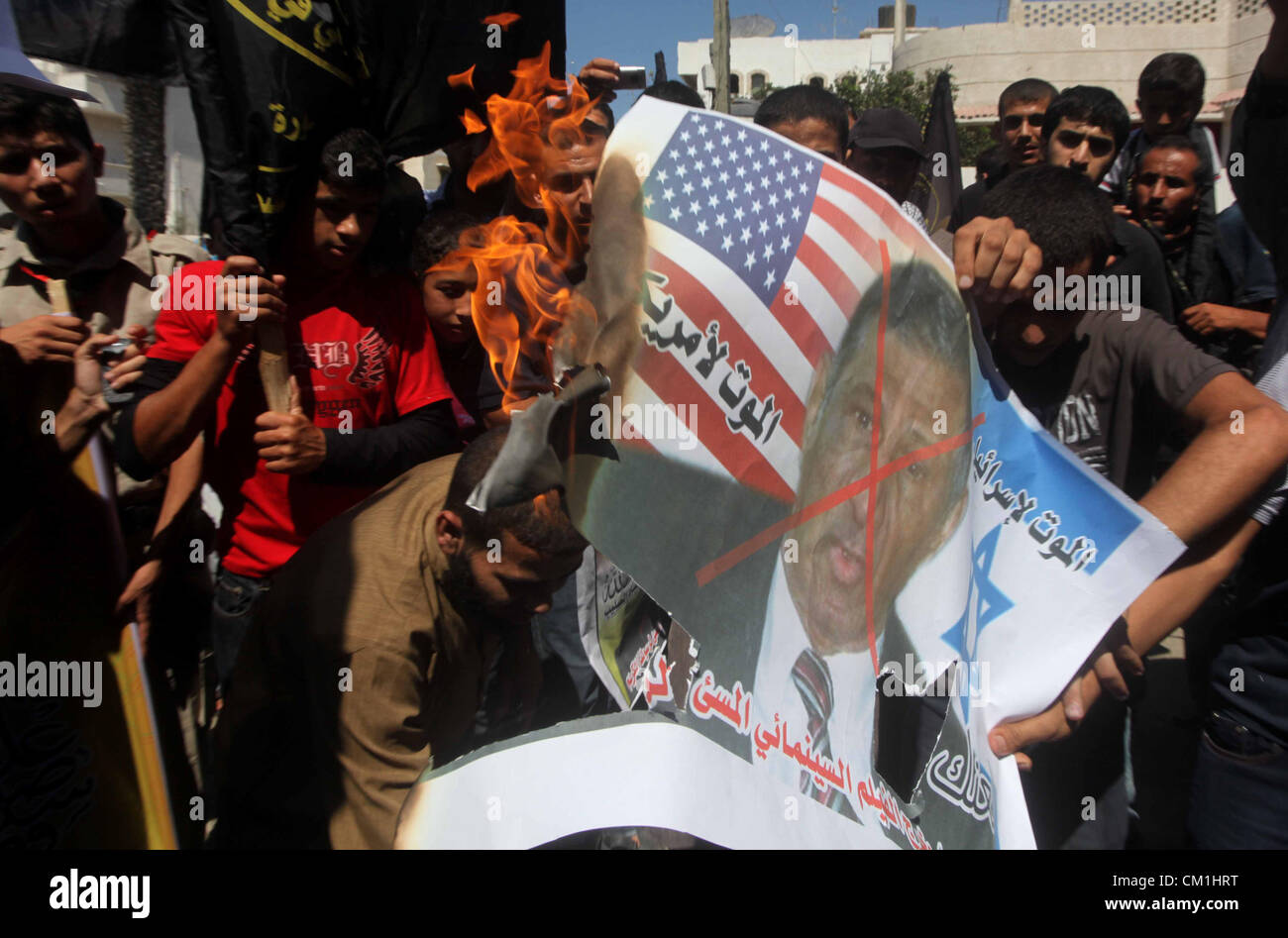 Sept. 14, 2012 - Gaza City, Gaza Strip, Palestinian Territory - Palestinians burn a portrait of the director of controversial film 'Innocence of Muslims' during a demonstration in Khan Younis southern Gaza strip, on September 14, 2012. The controversial low budget film reportedly made by an Israeli-American which portrays Muslims as immoral and gratuitous, sparked fury in Libya, where four Americans including the ambassador were killed on Tuesday when a mob attacked the US consulate in Benghazi, and has led to protests outside US missions in Morocco, Sudan, Egypt, Tunisia and Yemen  (Credit Im Stock Photo