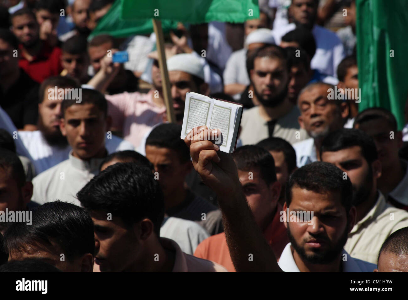 Sept. 14, 2012 - Gaza City, Gaza Strip, Palestinian Territory - Palestinians hold placards as they shout anti-U.S. slogans during a demonstration against the controversial film 'Innocence of Muslims' in Khan Younis southern Gaza strip, on September 14, 2012. The controversial low budget film reportedly made by an Israeli-American which portrays Muslims as immoral and gratuitous, sparked fury in Libya, where four Americans including the ambassador were killed on Tuesday when a mob attacked the US consulate in Benghazi, and has led to protests outside US missions in Morocco, Sudan, Egypt, Tunisi Stock Photo