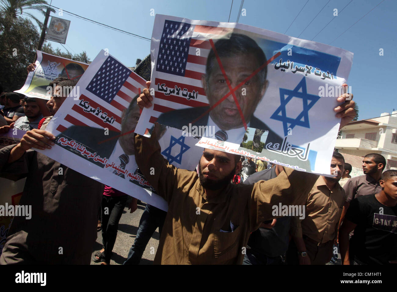 Sept. 14, 2012 - Gaza City, Gaza Strip, Palestinian Territory - Palestinians hold placards as they shout anti-U.S. slogans during a demonstration against the controversial film 'Innocence of Muslims' in Khan Younis southern Gaza strip, on September 14, 2012. The controversial low budget film reportedly made by an Israeli-American which portrays Muslims as immoral and gratuitous, sparked fury in Libya, where four Americans including the ambassador were killed on Tuesday when a mob attacked the US consulate in Benghazi, and has led to protests outside US missions in Morocco, Sudan, Egypt, Tunisi Stock Photo