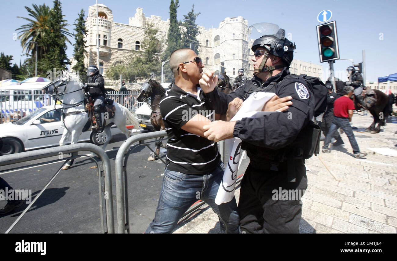 Sept. 14, 2012 - Jerusalem, Jerusalem, Palestinian Territory - Israeli policeman clashes with a Palestinian protester during a demonstration against the controversial film 'Innocence of Muslims' in front of al-Aqsa Mosqe in Jerusalem, on September 14, 2012. The controversial low budget film reportedly made by an Israeli-American which portrays Muslims as immoral and gratuitous, sparked fury in Libya, where four Americans including the ambassador were killed on Tuesday when a mob attacked the US consulate in Benghazi, and has led to protests outside US missions in Morocco, Sudan, Egypt, Tunisia Stock Photo