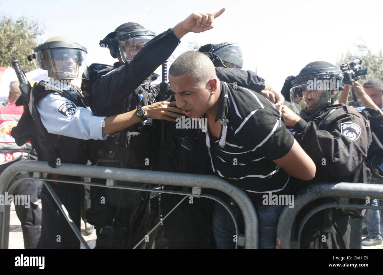 Sept. 14, 2012 - Jerusalem, Jerusalem, Palestinian Territory - Israeli policemen detain a Palestinian protester during a demonstration against the controversial film 'Innocence of Muslims' in front of al-Aqsa Mosqe in Jerusalem, on September 14, 2012. The controversial low budget film reportedly made by an Israeli-American which portrays Muslims as immoral and gratuitous, sparked fury in Libya, where four Americans including the ambassador were killed on Tuesday when a mob attacked the US consulate in Benghazi, and has led to protests outside US missions in Morocco, Sudan, Egypt, Tunisia and Y Stock Photo