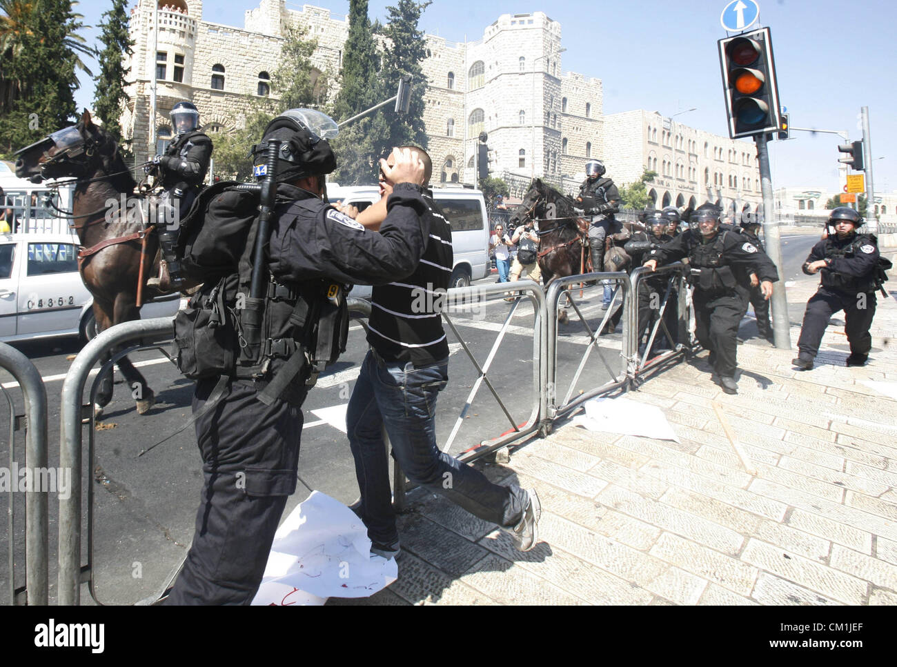 Sept. 14, 2012 - Jerusalem, Jerusalem, Palestinian Territory - Israeli policeman clashes with a Palestinian protester during a demonstration against the controversial film 'Innocence of Muslims' in front of al-Aqsa Mosqe in Jerusalem, on September 14, 2012. The controversial low budget film reportedly made by an Israeli-American which portrays Muslims as immoral and gratuitous, sparked fury in Libya, where four Americans including the ambassador were killed on Tuesday when a mob attacked the US consulate in Benghazi, and has led to protests outside US missions in Morocco, Sudan, Egypt, Tunisia Stock Photo