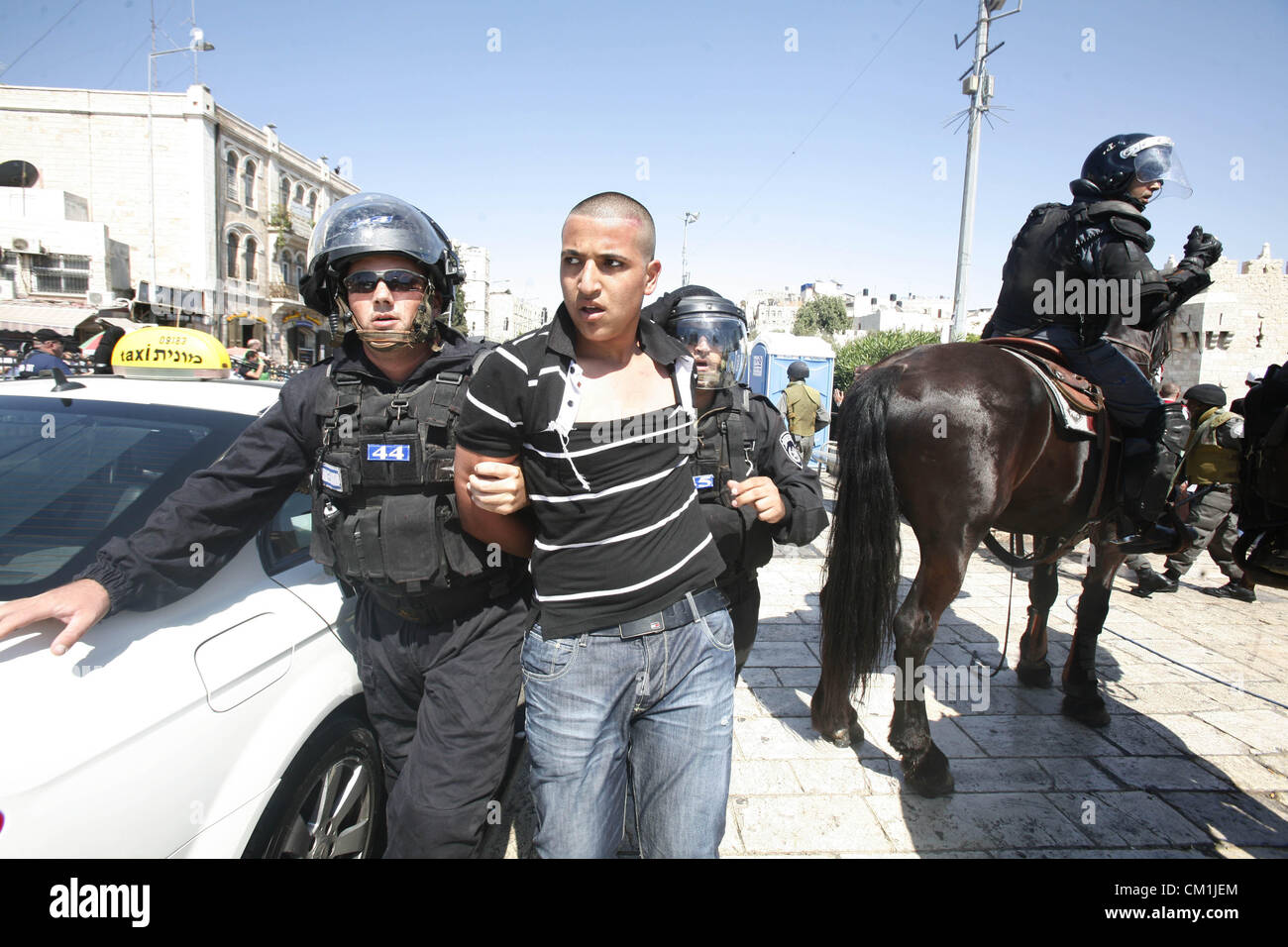 Sept. 14, 2012 - Jerusalem, Jerusalem, Palestinian Territory - Israeli policemen detain a Palestinian protester during a demonstration against the controversial film 'Innocence of Muslims' in front of al-Aqsa Mosqe in Jerusalem, on September 14, 2012. The controversial low budget film reportedly made by an Israeli-American which portrays Muslims as immoral and gratuitous, sparked fury in Libya, where four Americans including the ambassador were killed on Tuesday when a mob attacked the US consulate in Benghazi, and has led to protests outside US missions in Morocco, Sudan, Egypt, Tunisia and Y Stock Photo