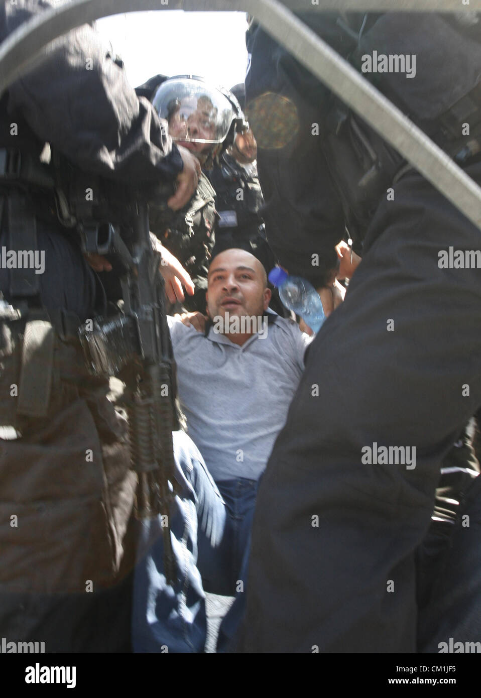 Sept. 14, 2012 - Jerusalem, Jerusalem, Palestinian Territory - Israeli policemen detain a Palestinian protester during a demonstration against the controversial film 'Innocence of Muslims' in front of al-Aqsa Mosqe in Jerusalem, on September 14, 2012. The controversial low budget film reportedly made by an Israeli-American which portrays Muslims as immoral and gratuitous, sparked fury in Libya, where four Americans including the ambassador were killed on Tuesday when a mob attacked the US consulate in Benghazi, and has led to protests outside US missions in Morocco, Sudan, Egypt, Tunisia and Y Stock Photo