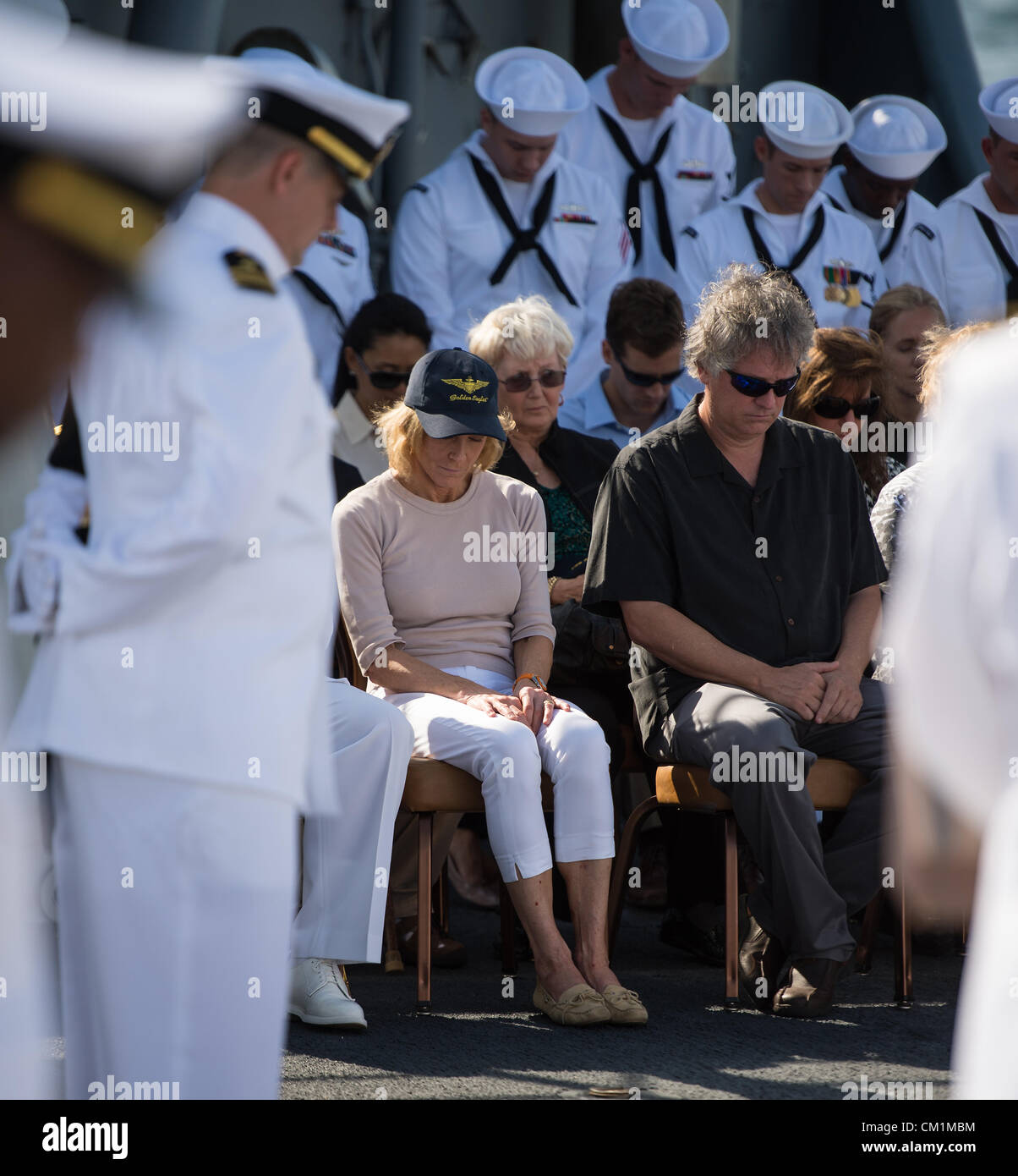 Carol Armstrong, wife of Neil Armstrong, Eric Rick Armstrong, son of Neil Armstrong, and other family members are seen bowing their heads during the burial at sea service for her husband Apollo 11 astronaut Neil Armstrong September 14, 2012 aboard the USS Philippine Sea in the Atlantic Ocean. Armstrong, the first man to walk on the moon during the 1969 Apollo 11 mission, died August 25. He was 82. Stock Photo