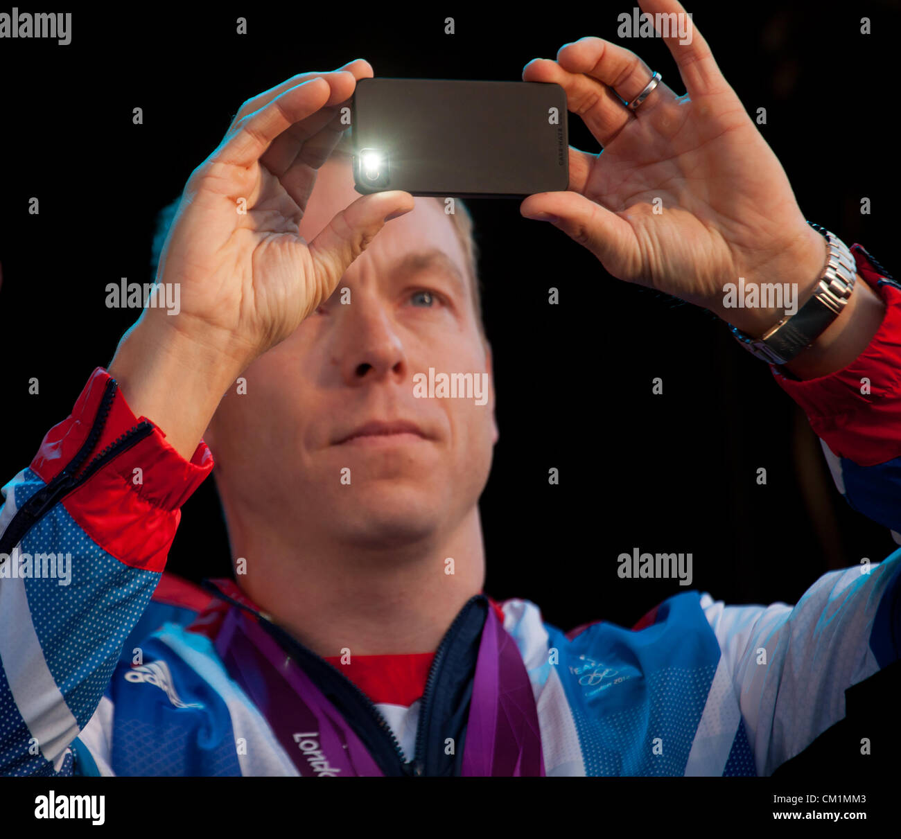 14th September, 2012. The flash goes off as Sir Chris Hoy, Team GB's greatest ever Olympian, takes a photo of the crowd at the end of the homecoming parade to honour Scotland's Olympians and Paralympians in George Square, Glasgow. Stock Photo