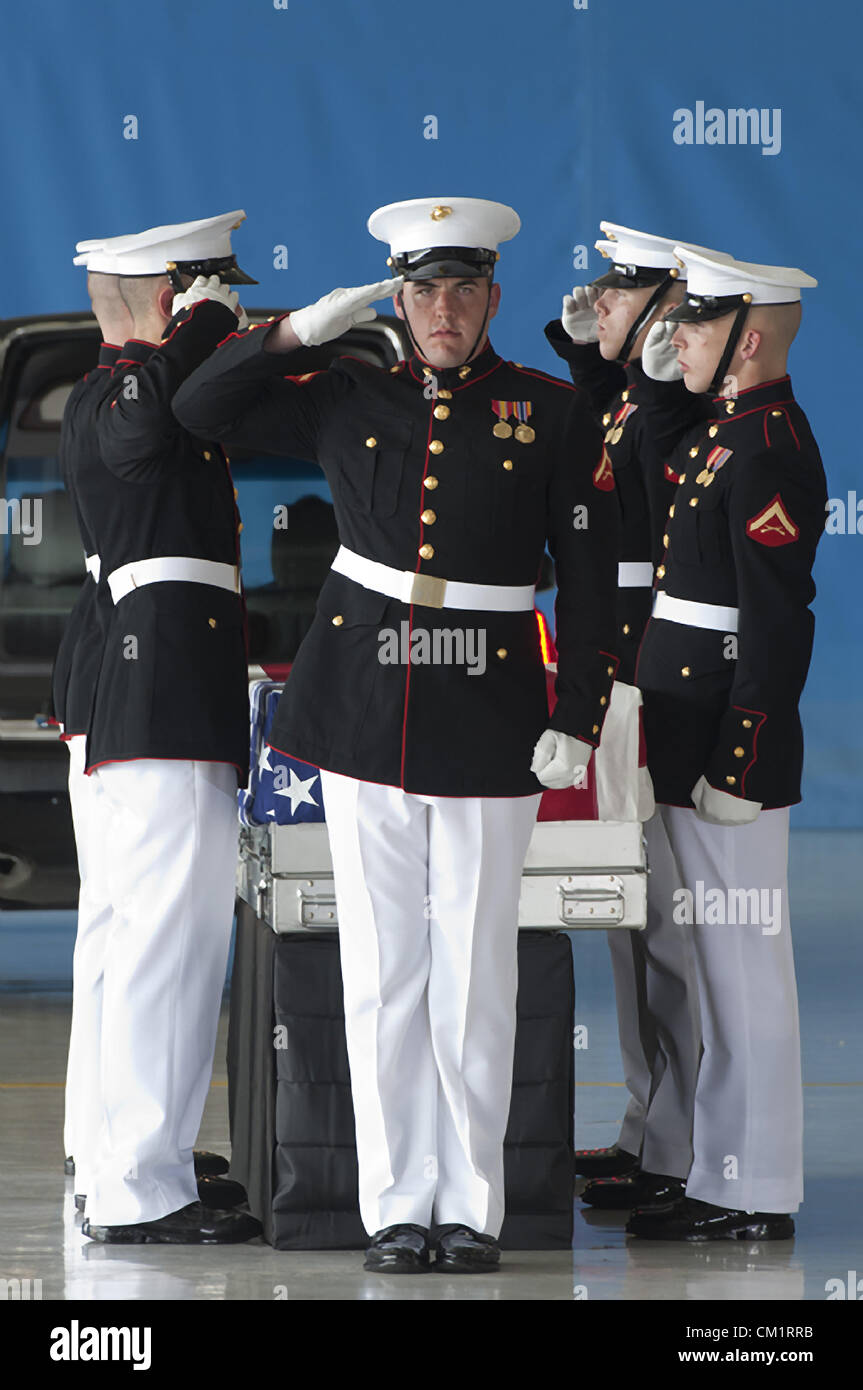 The United States Marine Corps Honor Guard salute the remains of four American's killed by mobs at the Benghazi Consulate during a transfer ceremony for the September 14, 2012 at Joint Base Andrews, Maryland. Stock Photo