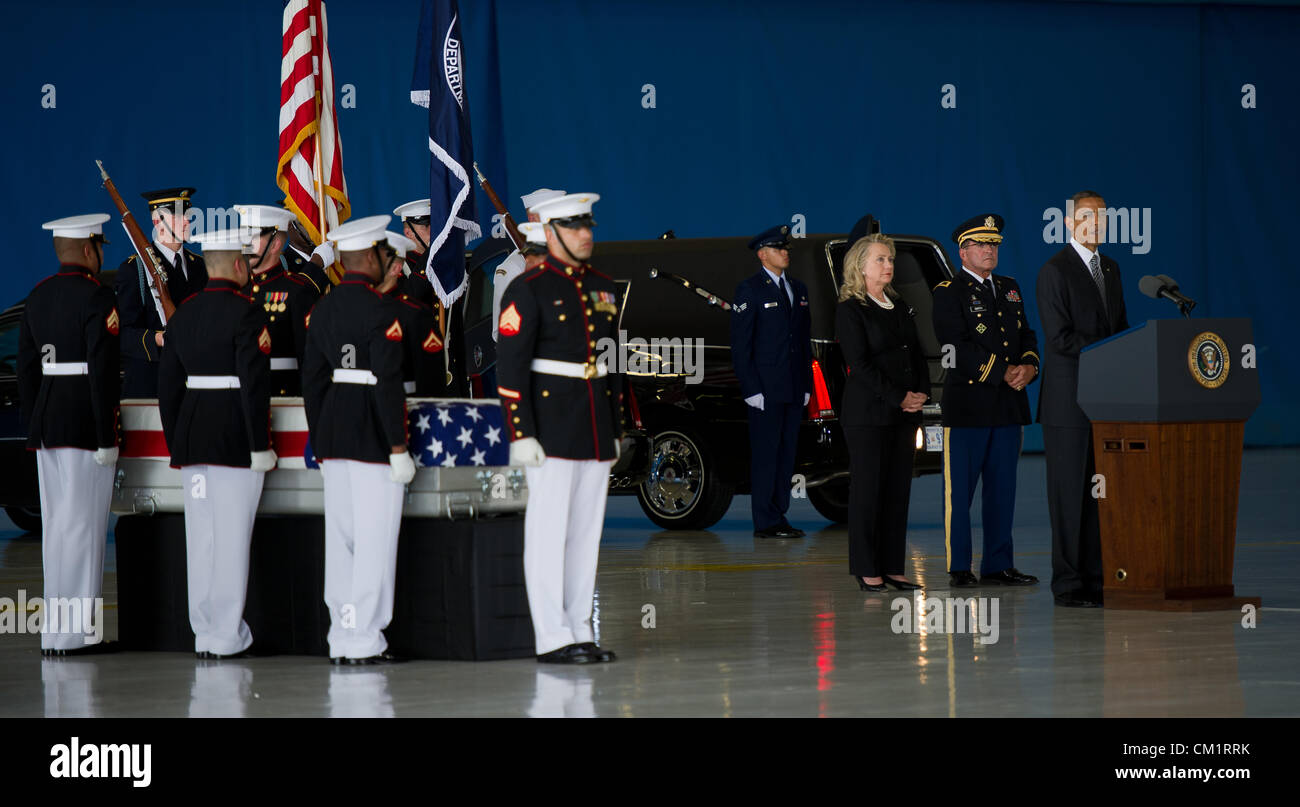 US President Barack Obama speaks at a transfer ceremony for the four American's killed by mobs at the Benghazi Consulate as Secretary of State Hillary Rodham Clinton looks on September 14, 2012 at Joint Base Andrews, Maryland. Stock Photo