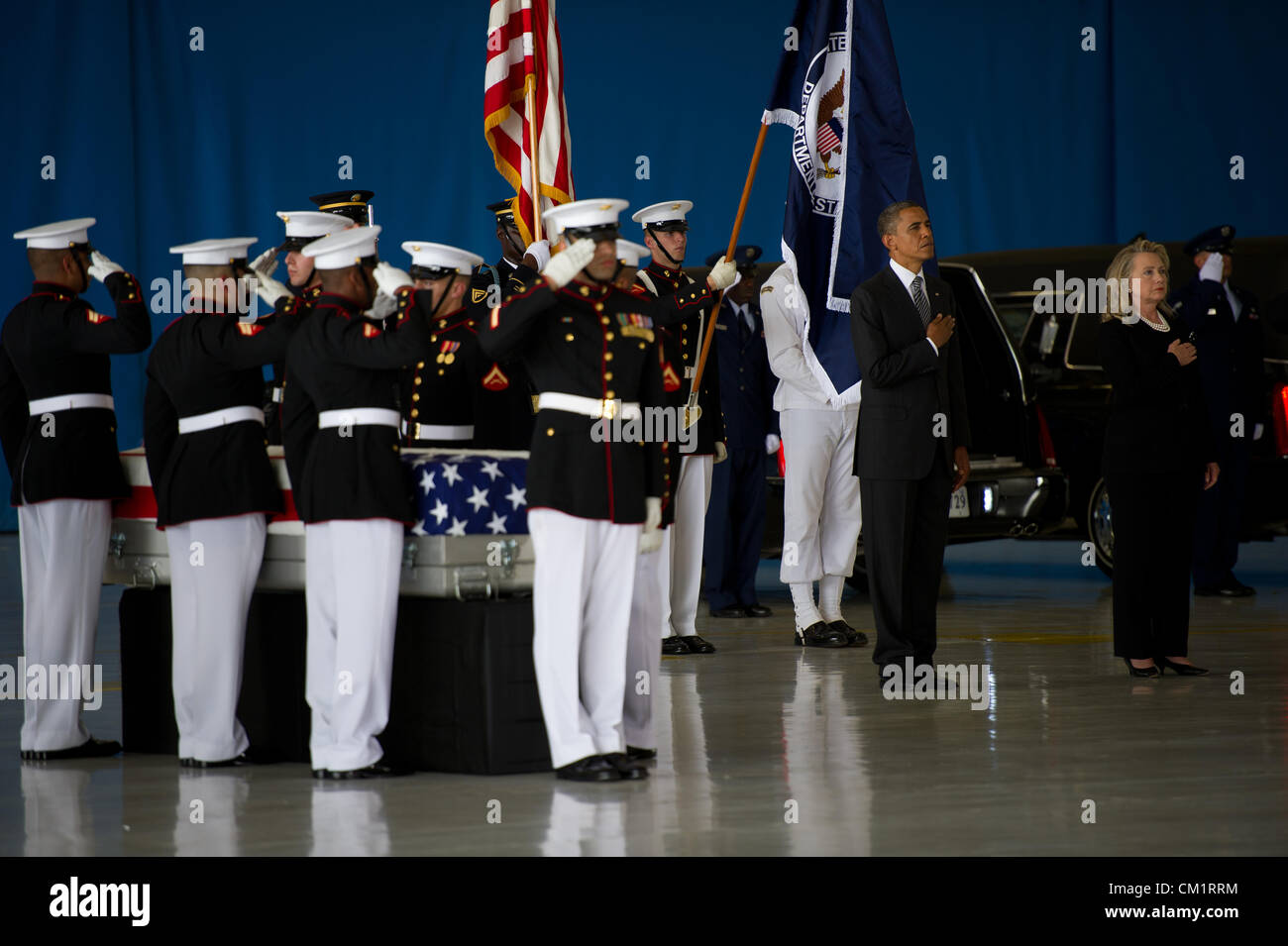 US President Barack Obama and Secretary of State Hillary Rodham Clinton stand in honor during a transfer ceremony for the four American's killed by mobs at the Benghazi Consulate September 14, 2012 at Joint Base Andrews, Maryland. Stock Photo