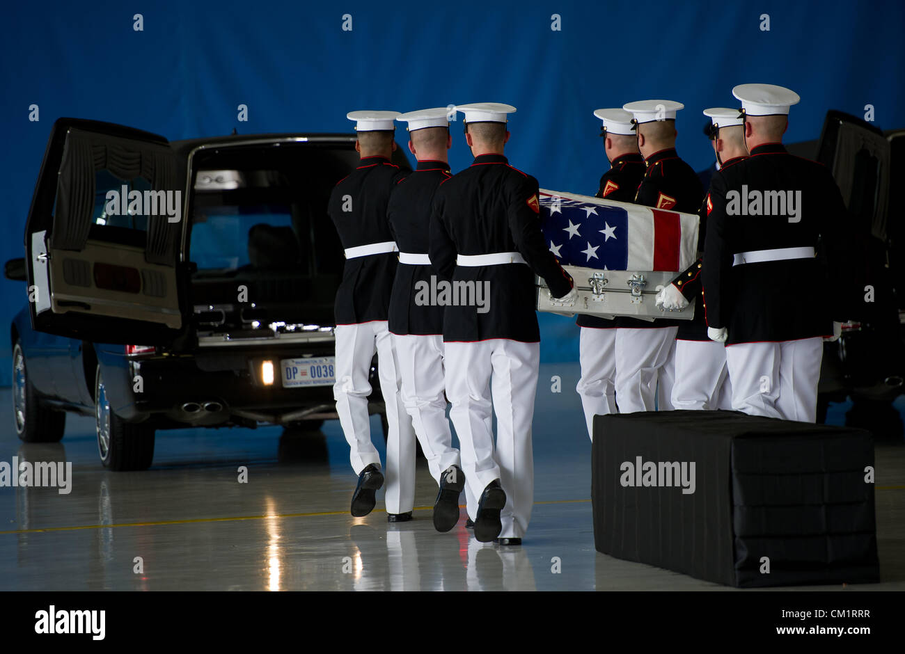 The United States Marine Corps Honor Guard carry the remains of four American's killed by mobs at the Benghazi Consulate during a transfer ceremony for the September 14, 2012 at Joint Base Andrews, Maryland. Stock Photo