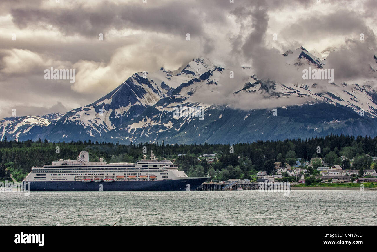 July 4, 2012 - Haines, Alaska, US - The ms Zaandam, a Holland America Line cruise ship, docked in Portage Cove at Haines, Alaska, with dramatic clouds and the majestic Chilkat Mountain Range as a spectacular backdrop. (Credit Image: © Arnold Drapkin/ZUMAPRESS.com) Stock Photo